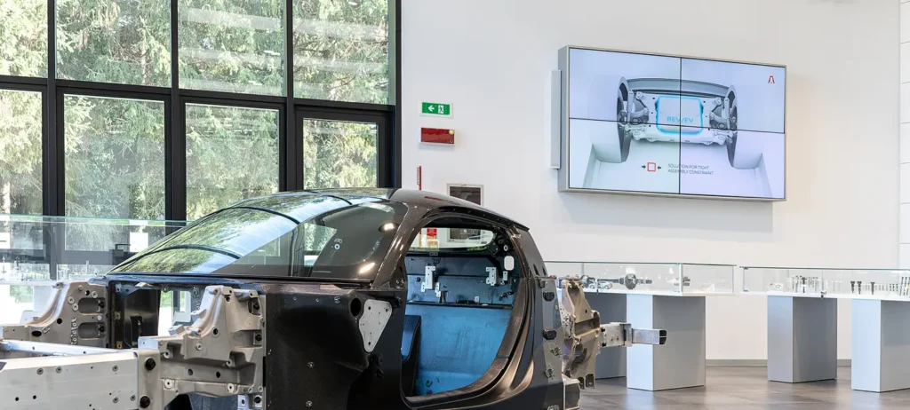 Car chassis displayed in modern showroom