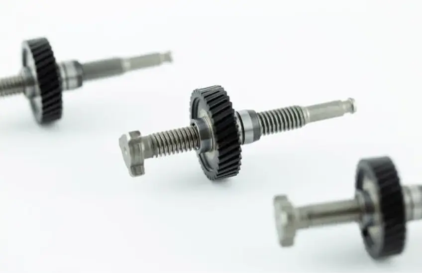 Metal gears and screws arranged neatly