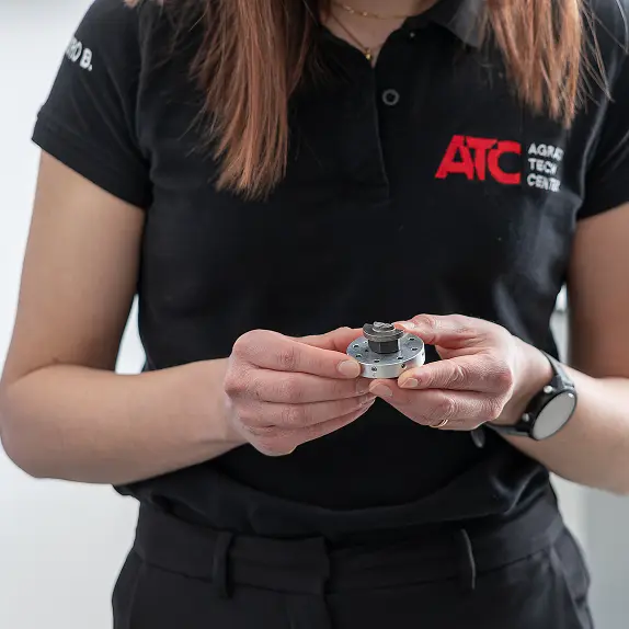 Person holding a mechanical component.