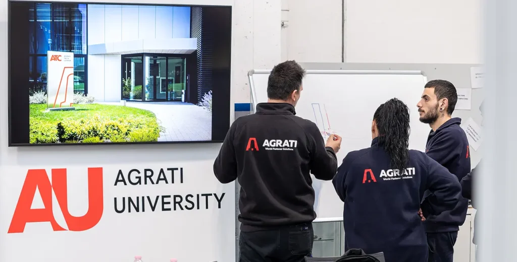 People discussing in front of presentation.